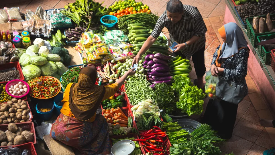 Picture of a woman selling food at a food market