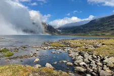 Landscape picture from the arctic with mountains, a blue sky and wetland.