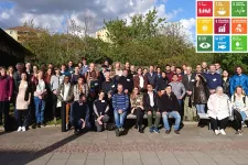 Group photo of participants at the spring meeting 2019. Outdoors with greens behind. Photo.